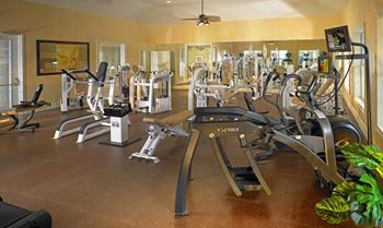 a room filled with lots of different types of exercise equipment